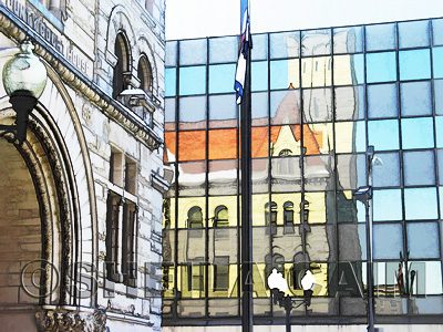 Reflections of old courthouse against walls of new glass building