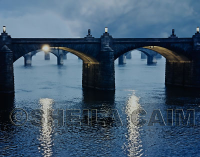 Water flowing under bridge in late evening