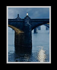 Water flowing under bridge in late evening thumbnail