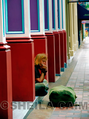 The harmonica player is oblivious to everything but his music. The street echoes his song. Shot with a Canon Powershot Pro 1 camera in Nashville, TN.