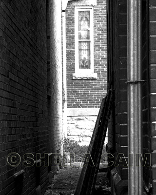 black and white church windows at end of alley
