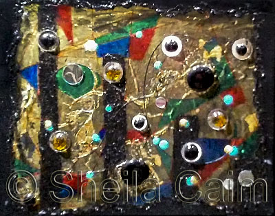 an abstract work with gold leaf, mirrors and glass beads