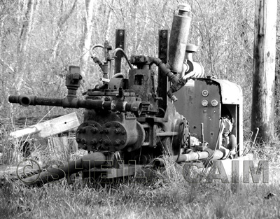 Black and white image of old oil field equipment