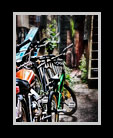 A pack of bikes and motorcycles in an alley thumbnail