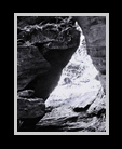 Black & white image of river flowing thru rocks