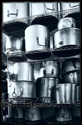 A still life of stacked cooking pots